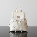 Polka Dot Lace Trim Backpack Bag front view on black glass