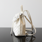 Polka Dot Lace Trim Backpack Bag side angle on black glass