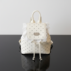 Polka Dot Lace Trim Backpack Bag overhead flat lay on black glass